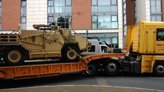 An armoured vehicle on top of a HGV lorry